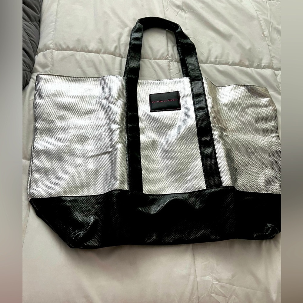 Victoria’s Secret handbag. Silver and black glam. Large bag with zipper closure.